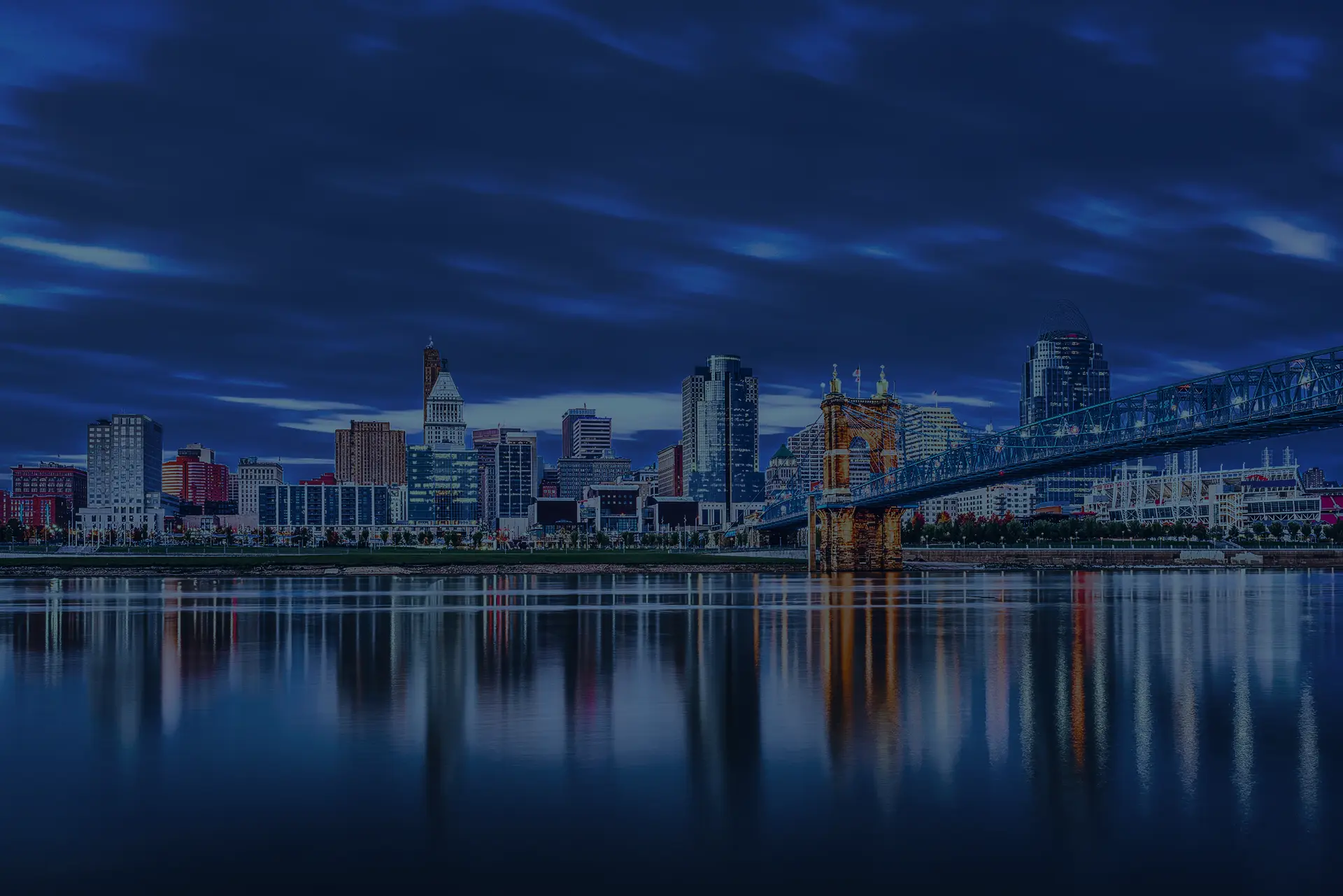 Cincinnati skyline and bridge reflecting in water, supporting MIS Solutions IT services.